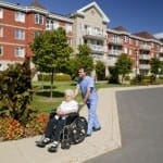 caregiver with elderly person in wheelchair
