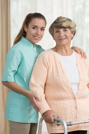 Elderly woman and caretaker using in home care services