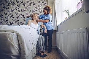 a woman receiving in-home care from a caregiver