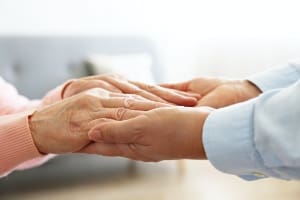 care giver holding hands of their patient