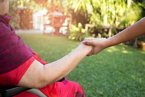 caregiver and patient holding hands for support for failure to thrive